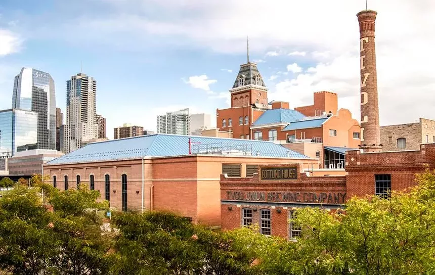 a brick building in front of a city skyline
