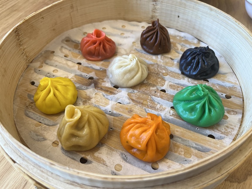 various colored dumplings in an open steamer basket