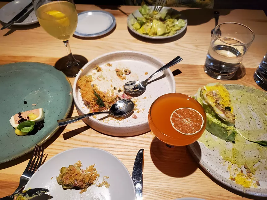 various plates on a table with partially eaten food