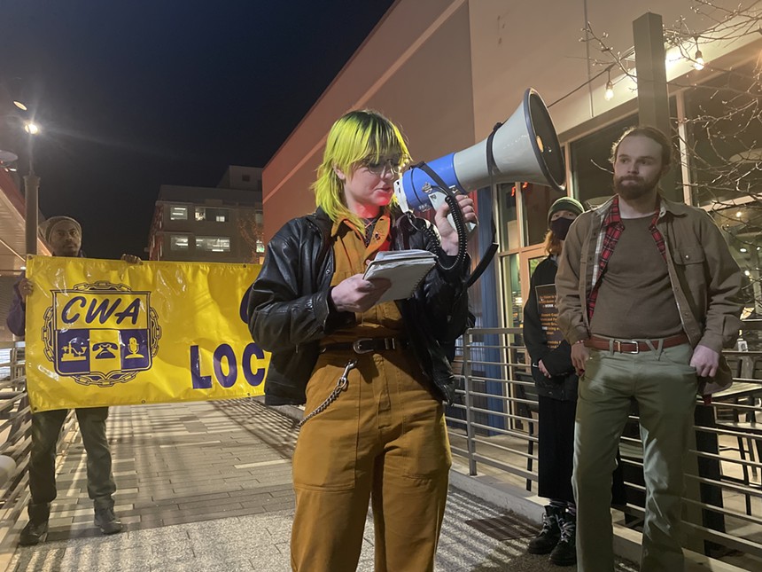 A person with yellow hair holding a megaphone.