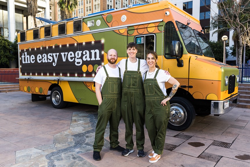 Three people in front of a food truck