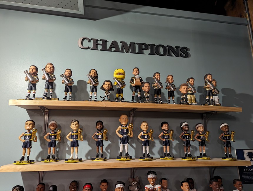A wall of bobbleheads from the most recent MLB, NHL, NBA and NFL champions.