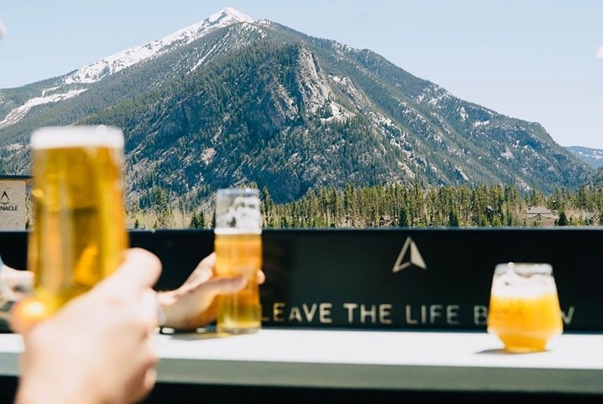 glasses of beer in front of a mountain view