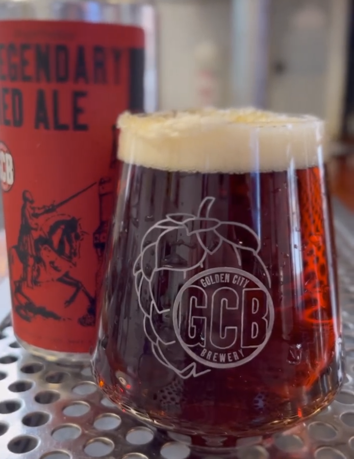 Red beer in a glass with a can.