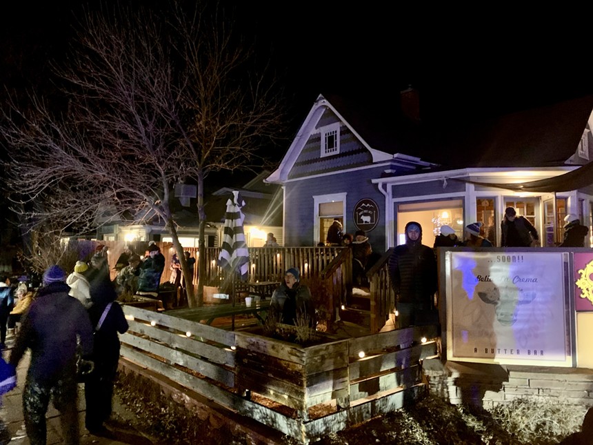 people gathered outside a home at night