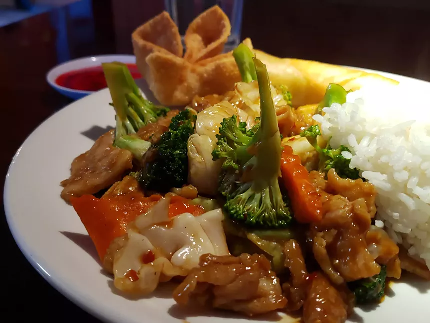chicken, vegetables and rice on a plate