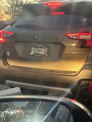 A subaru with an "I Hate Golf" license plate.