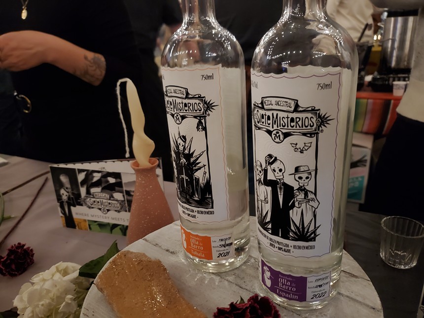 two bottles of mezcal with black and white labels