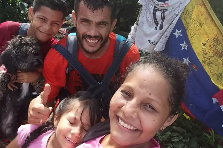 A family of migrants walks to the U.S. with their dog.
