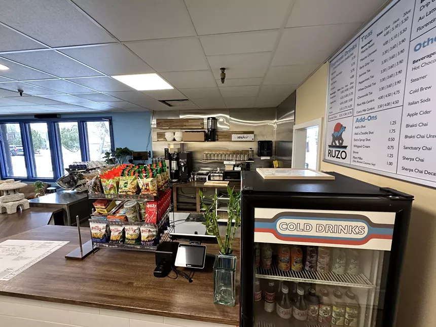 A grab-and-go refrigerator and snack rack on the Ruzo Coffee counter