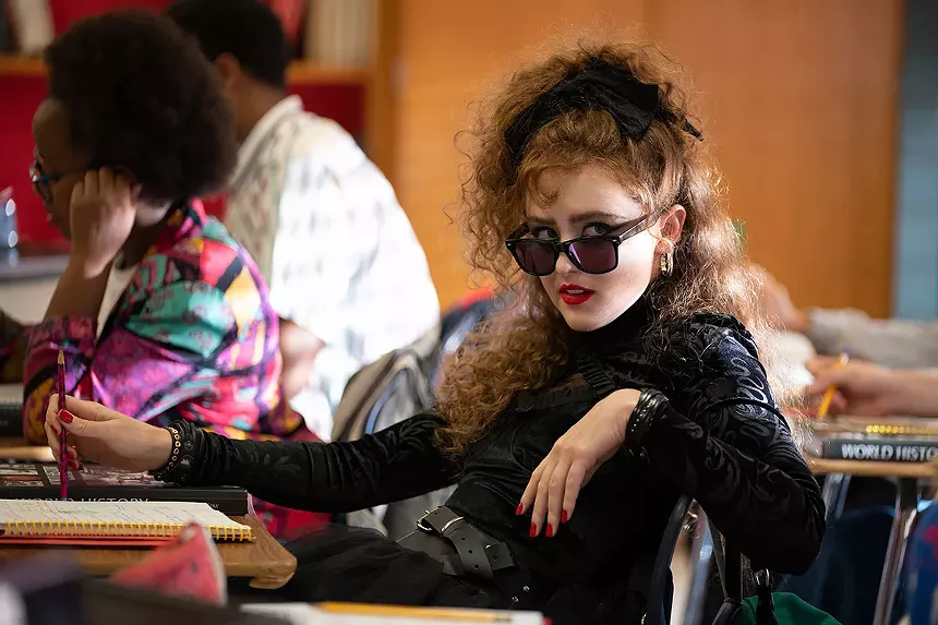 woman wearing sunglasses and a black bow in her hair