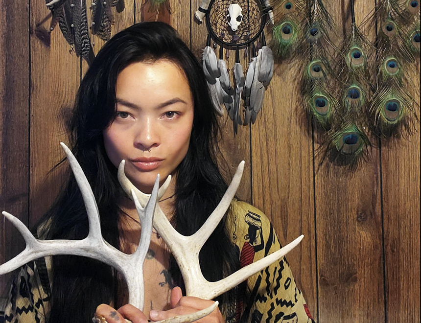 woman holding antlers