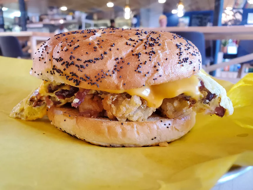 an egg and cheese sandwich on a oppy seed bun