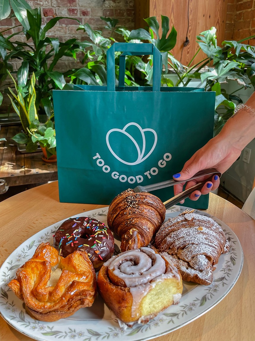 various pastries on a plate in front of a green bag