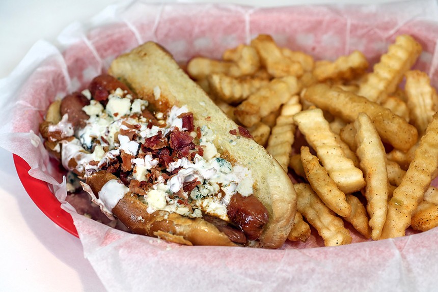 fries and a hot dog topped with bacon and blue cheese
