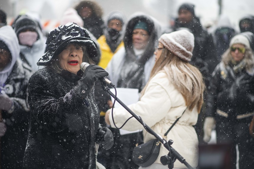 woman speaking into mic in snow
