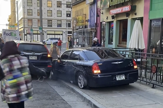 Black car does hit and run on parked vehicle downtown