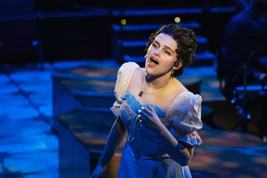 woman singing in a blue dress