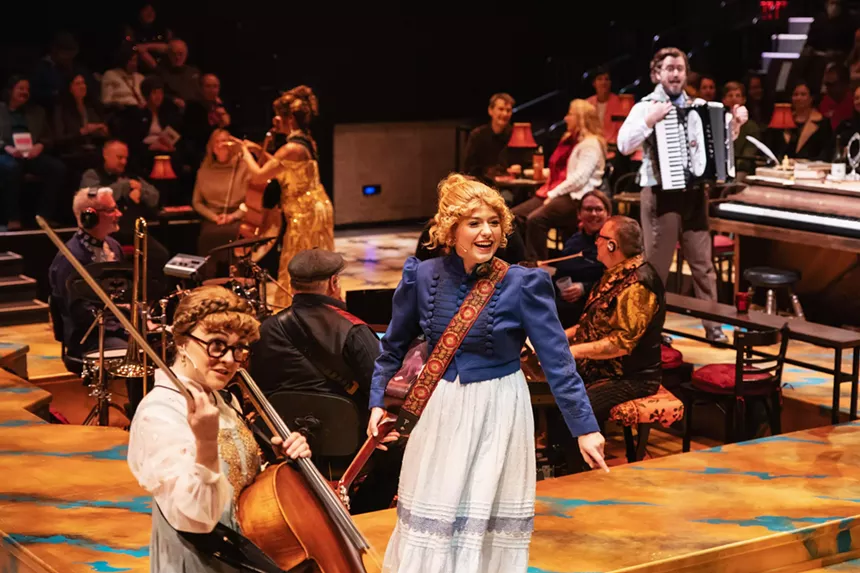 actors playing instruments on stage