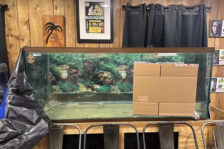 Broken glass fish tank with a hole in it.