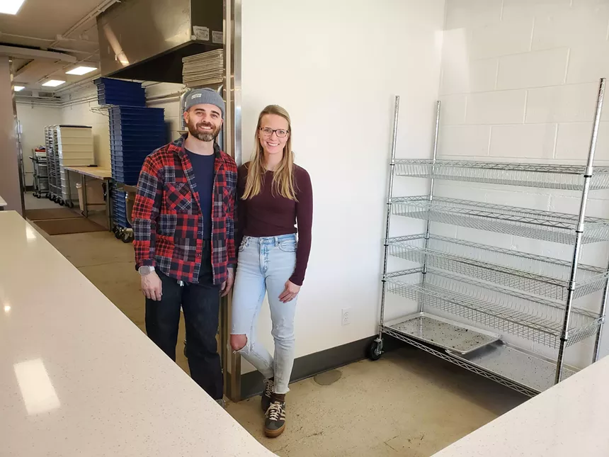 a man and a woman standing behind a counter