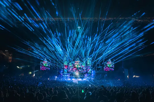 Blue lights shine on a DJ stage