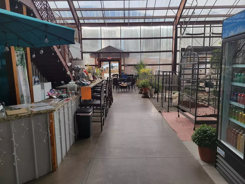 Charlotte Hot Springs check-in desk to the left and a beverage refrigerator to the right