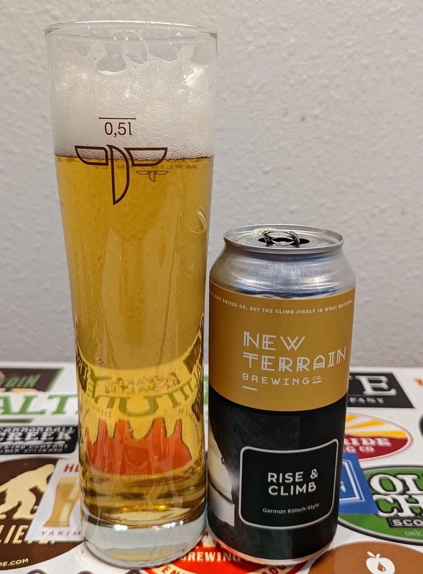 Golden yellow beer in a glass with a can.