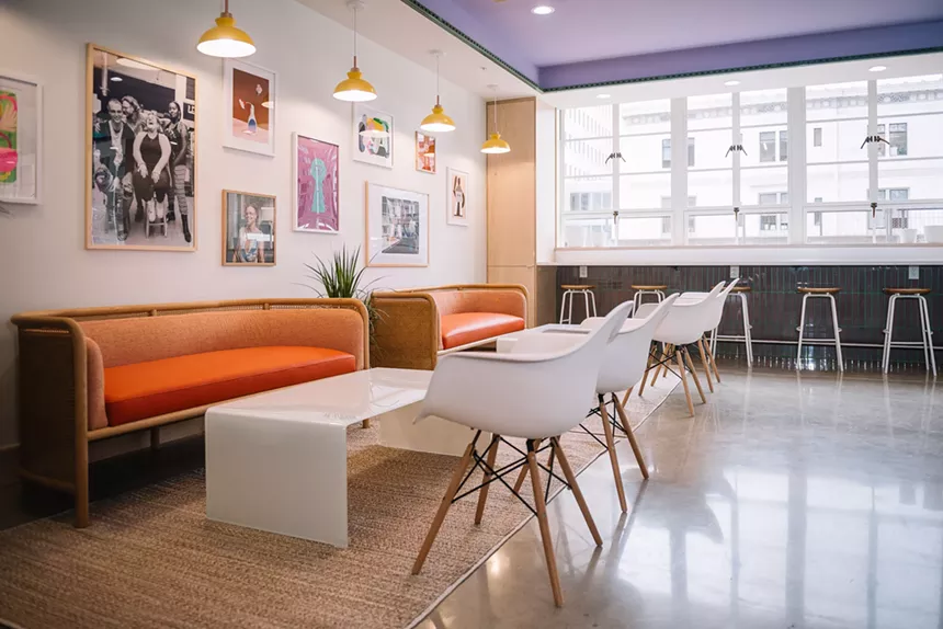 seating inside a bright room with art hanging on the wall