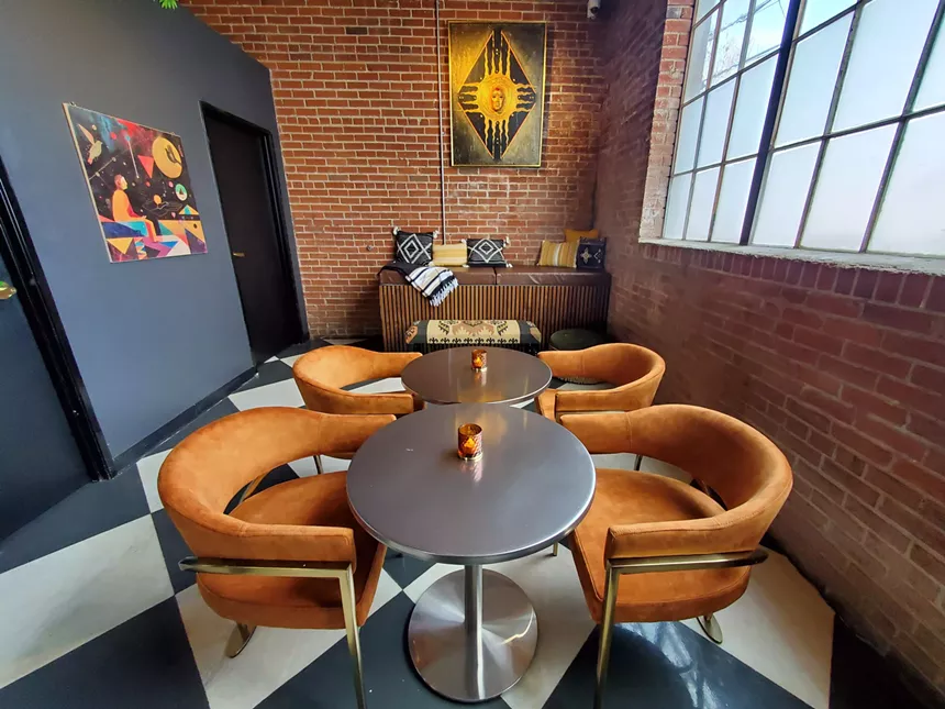 orange chairs around two small tables
