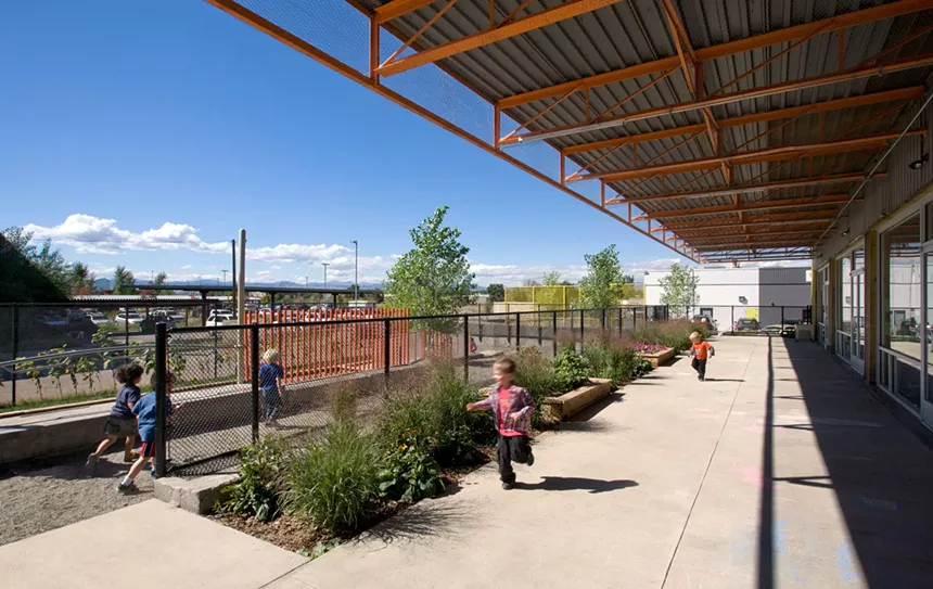 Toddlers run outside at a Denver pre-school