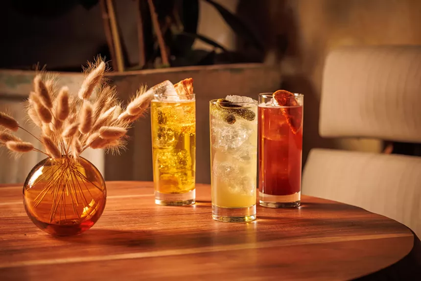three cocktails in glasses on a table