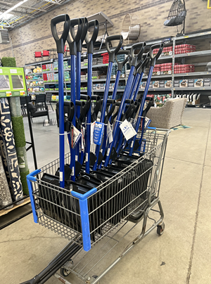 sbow shovels in a shopping cart at walmart