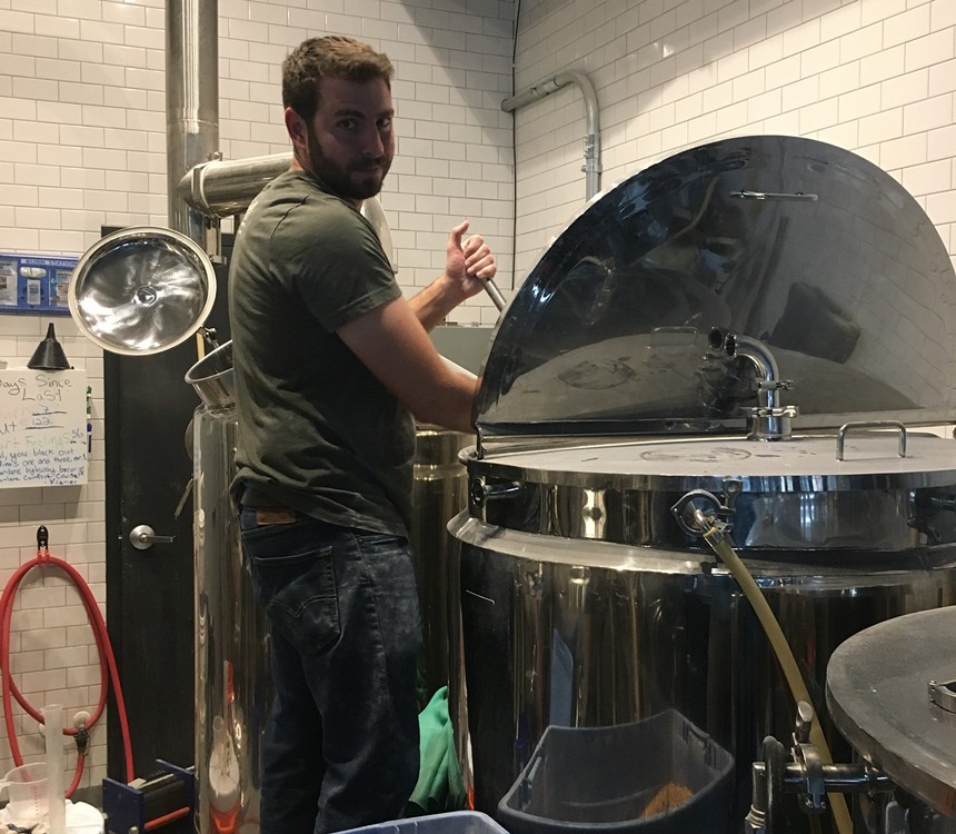 Brewer in a brewhouse making beer.