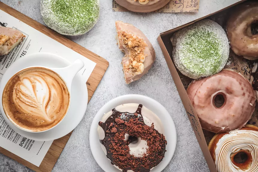 donuts and a latte in a coffee cup