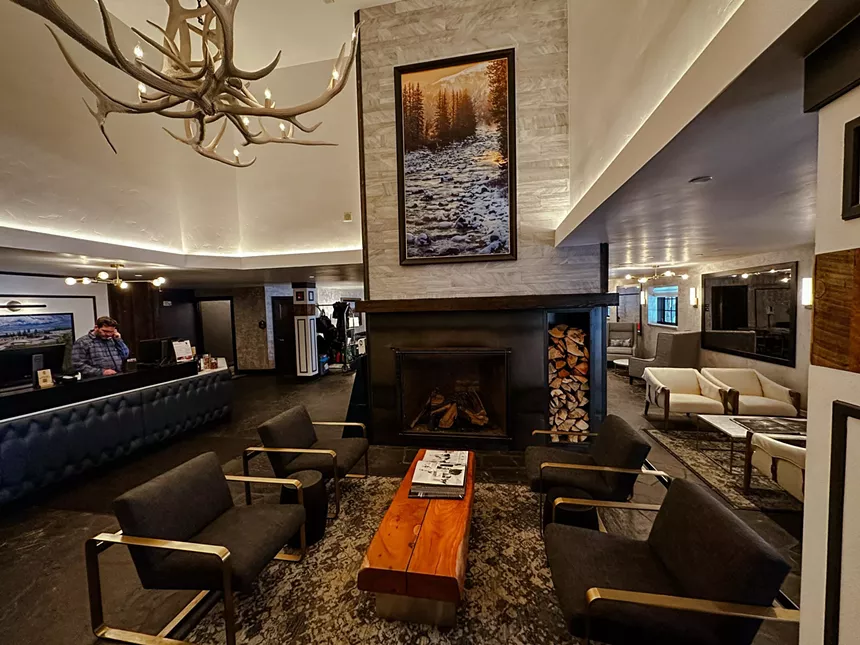 Large room with chairs and fireplace