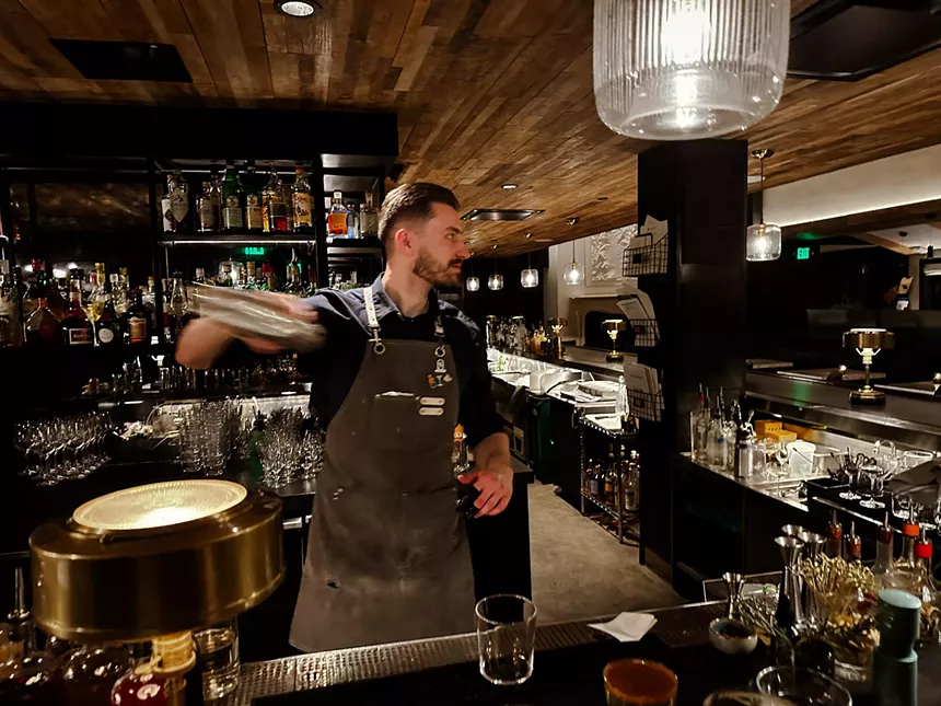 man shakes cocktail container
