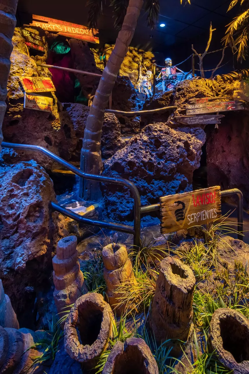 skeletons and signs on a cliff