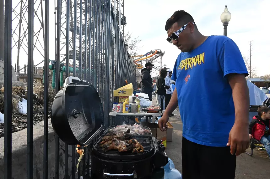 Man grills outside in parking lot