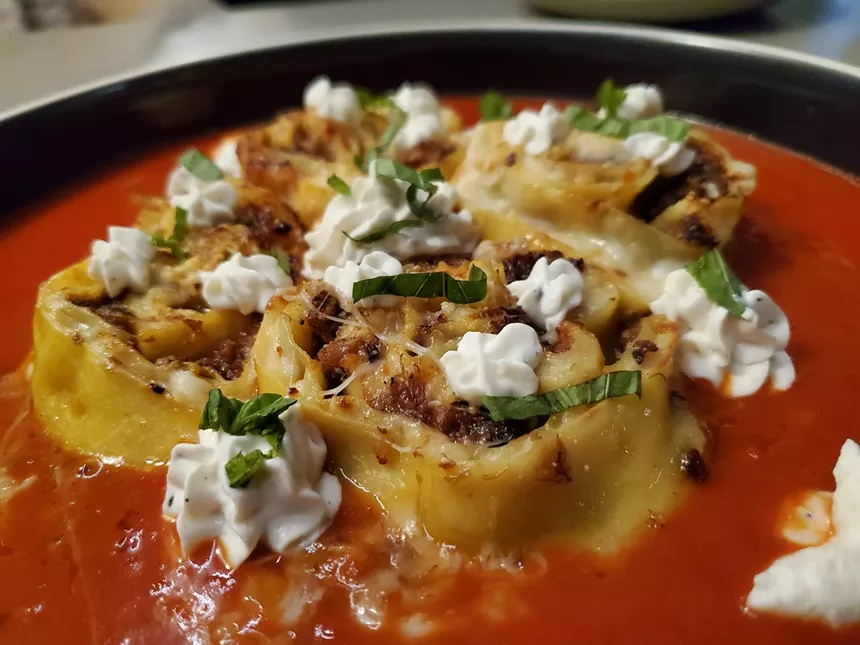 slices of lasagna over red sauce