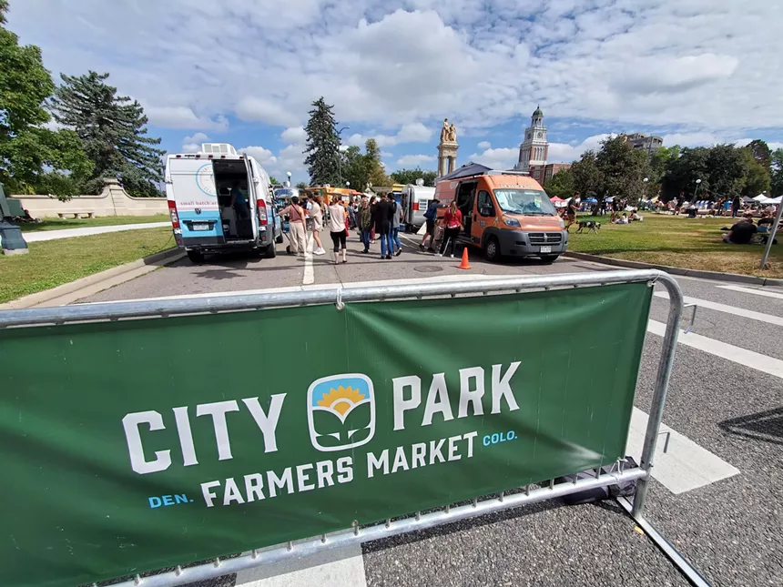 farmers market sign in front of food trucks