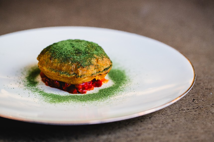 a masa dish on a plate with green dust garnish