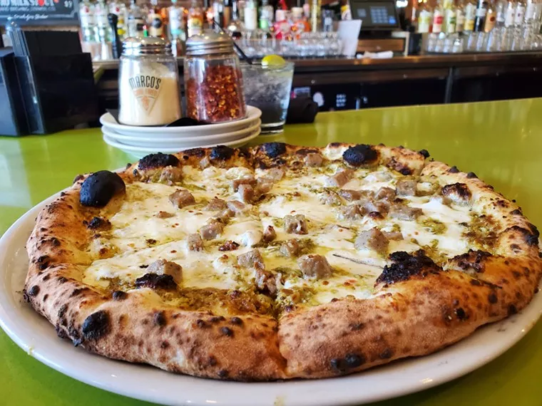 a pizza on a green counter
