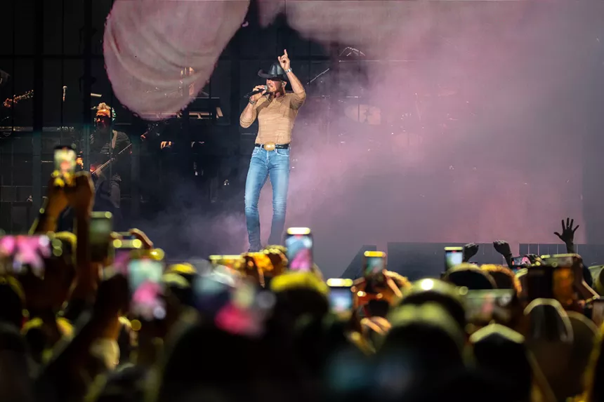 man in cowboy hat on stage