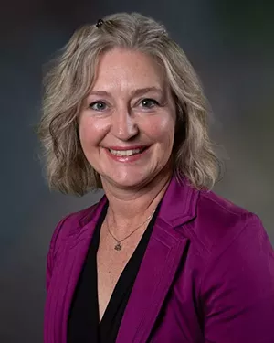 woman in purple shirt.