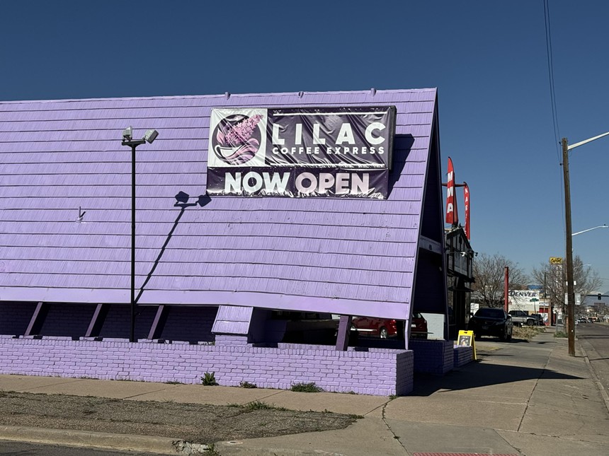 a purple building with a "now open" sign