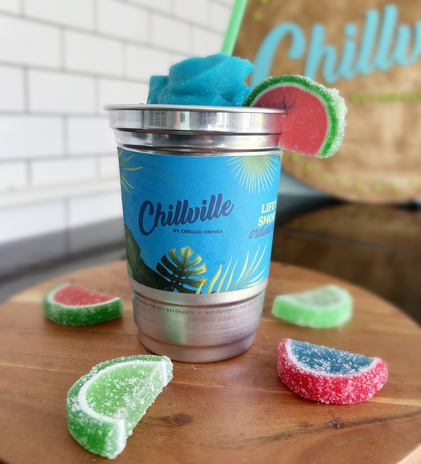 fruit slice gummies around an aluminum cup filled with slushie