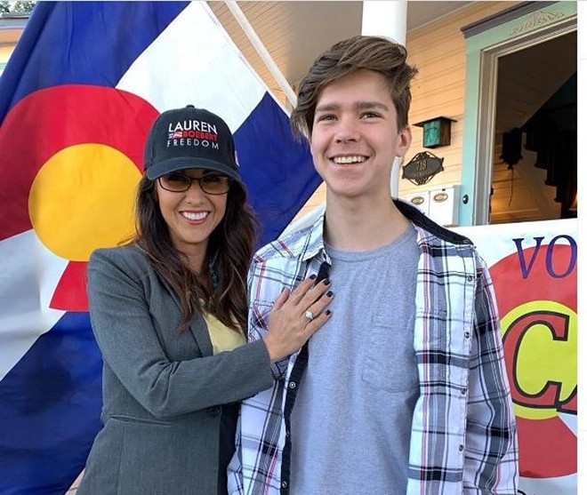 Colorado Representative Lauren Boebert standing with her eldest son Tyler.
