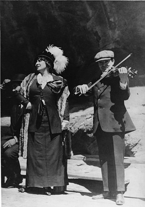 black and white photo of an opera singer and a man playing violin