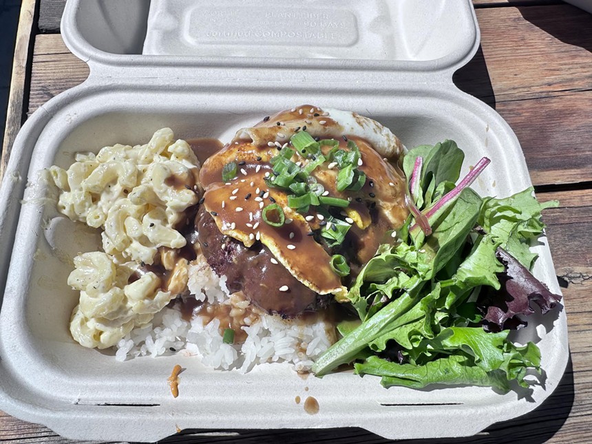 a loco moco, mac salad and greens in a to-go box